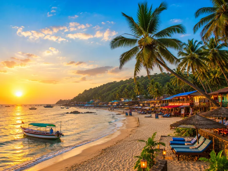 Goa tour package featuring beautiful beaches palm trees sunset views and water activities