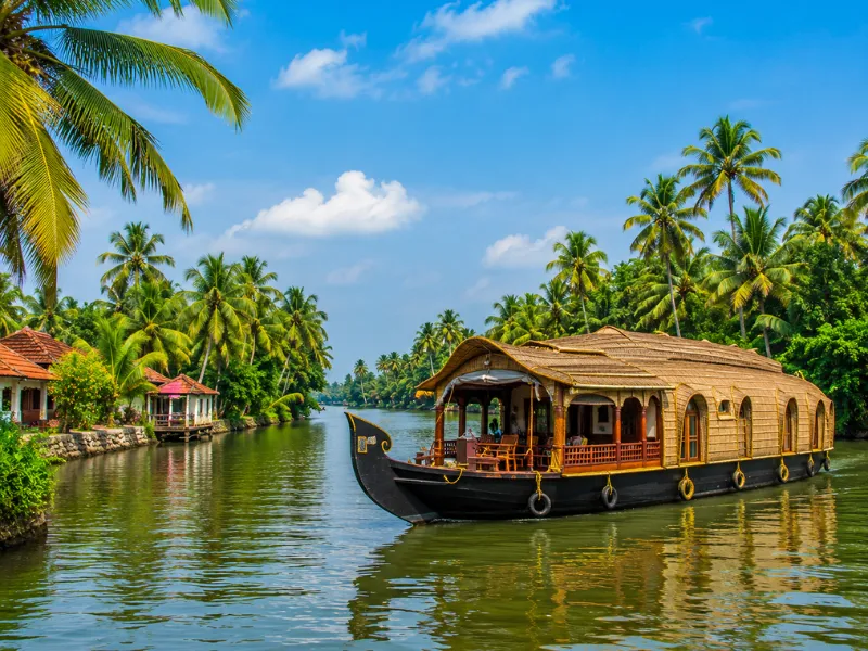 Kerala tour package featuring Alleppey backwaters houseboat coconut trees and scenic waterways
